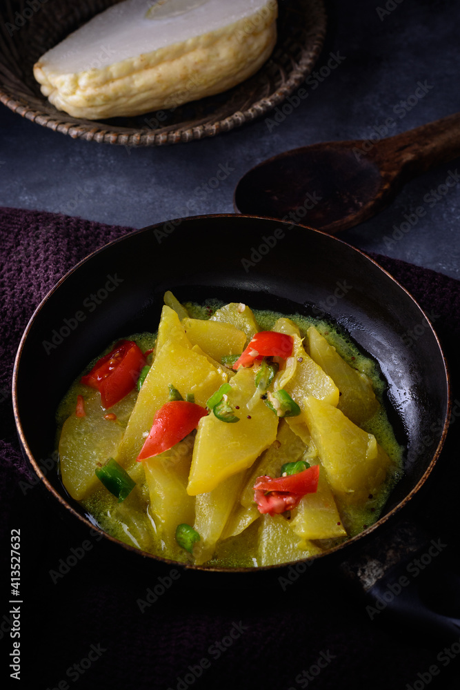 cooked chayote or chow chow dish on a pan, vegetarian dish on dark background cooked chayote or chow chow dish on a pan, vegetarian dish on dark background