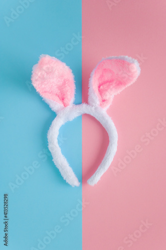 bunny ears headband happy easter on duo tone pink blue background with vertical orientation