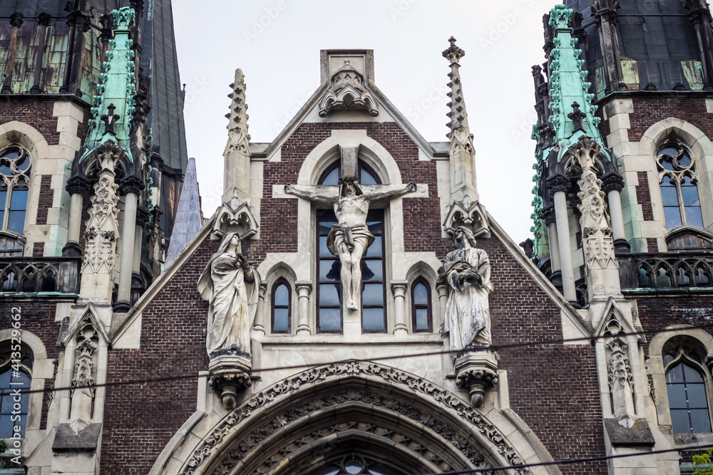 closeup facade with crucifix scene sculptures on catholic cathedral church in Lviv