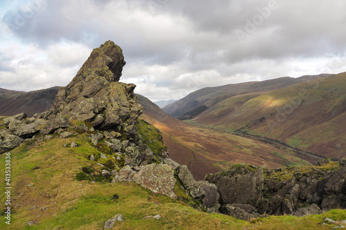 The rock formation known as 'The Howitzer' on Helm Crag overlooking the road through the valley, Lake District, UK photo