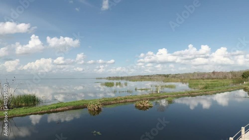 Brilliant blue sky and clouds reflect on Lake Apopka at Winter Garden Florida
