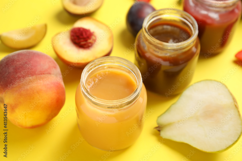 Healthy baby food and ingredients on yellow background Healthy baby food and ingredients on yellow background