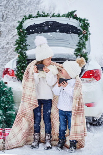two small children in the winter forest