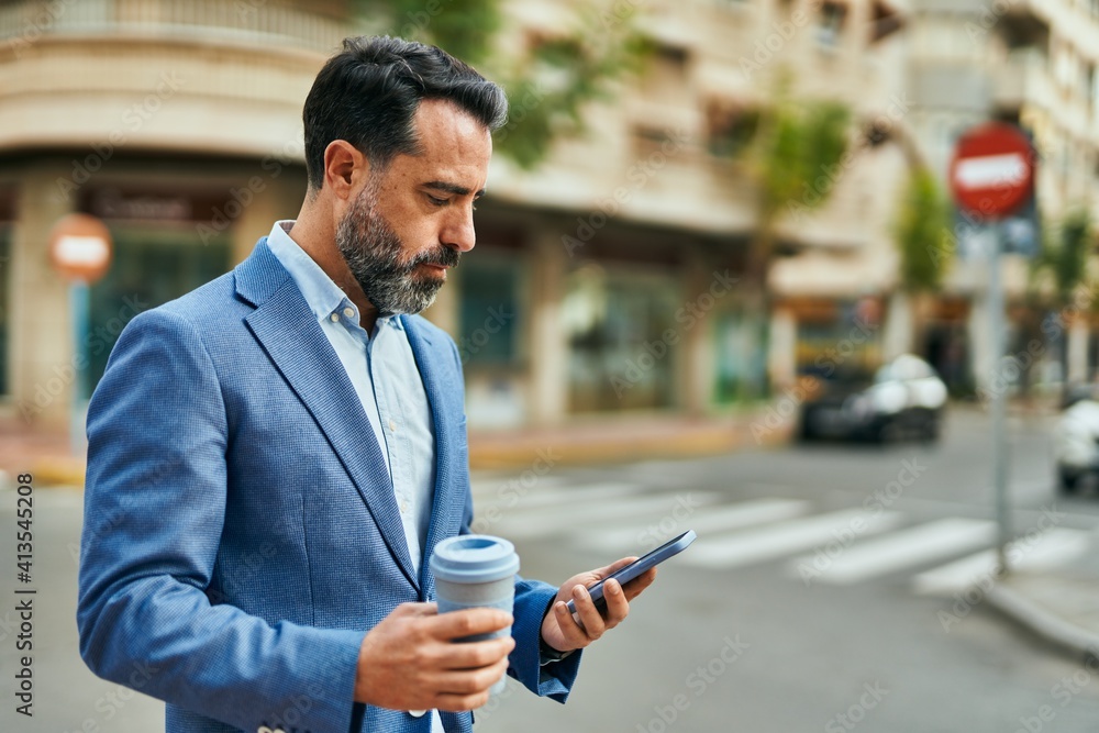 Middle age businessman using smartphone and drinking coffee at the city. Middle age businessman using smartphone and drinking coffee at the city.
