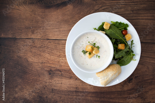 A Bowl of Clam Chowder and a Salad