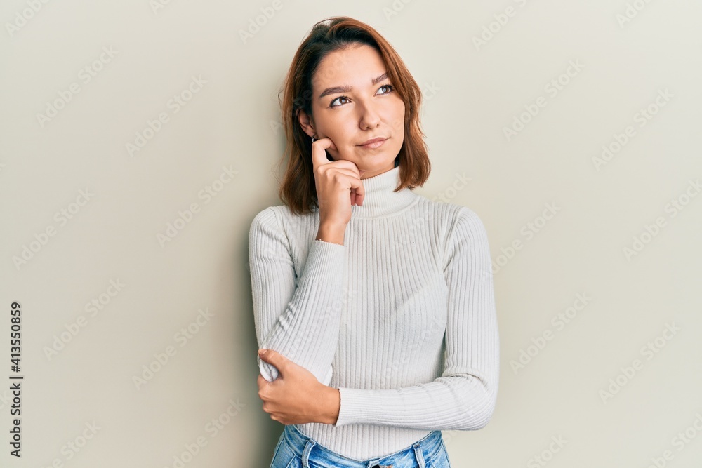 Young caucasian woman wearing casual clothes thinking concentrated about doubt with finger on chin and looking up wondering Young caucasian woman wearing casual clothes thinking concentrated about doubt with finger on chin and looking up wondering