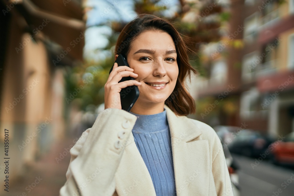 Young hispanic woman smiling happy talking on the smartphone at the city. Young hispanic woman smiling happy talking on the smartphone at the city.