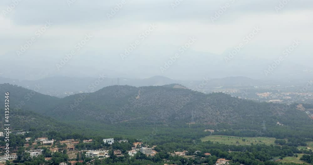 Beautiful landscape aerial frame. Valley mountains with trees and forests, houses and villages in mountain ranges with peaks Beautiful landscape aerial frame. Valley mountains with trees and forests, houses and villages in mountain ranges with peaks