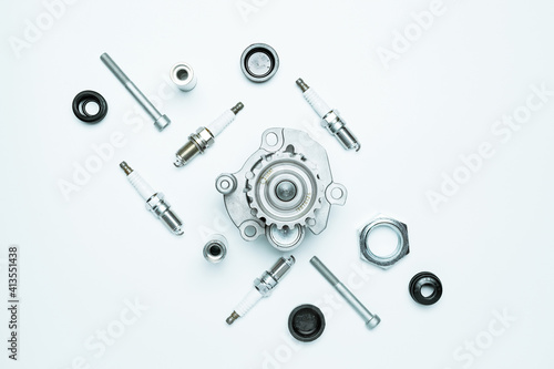 Car motor parts. Auto motor mechanic spare or automotive piece on white background. Set of new metal car part. Flat lay, top view, copy space.