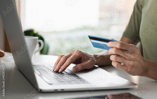 Woman using laptop computer with credit card making online payment. Business, online shopping, e-commerce, internet banking, spending money, working from home concept