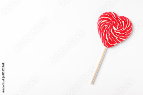 Sweet heart shaped lollipop on white background, top view with space for text. Valentine's day celebration