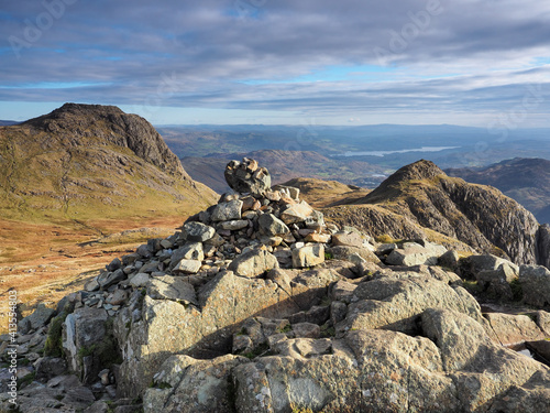 View to Harrison Stickle from cairn on Pike of Stickle, overlooking Loft Crag with Windermere lake in the background, Langdale Pikes, Lake District, UK photo