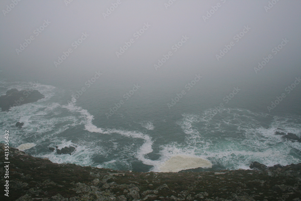 view of ocean cliffs with fog. Brittany, France.