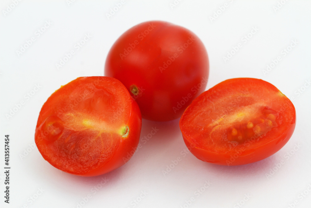 Cross section of cherry tomatoes on white background, closeup