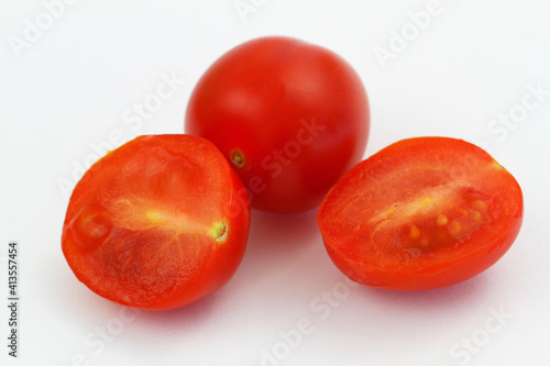 Obraz na płótnie Cross section of cherry tomatoes on white background, closeup
w salonie