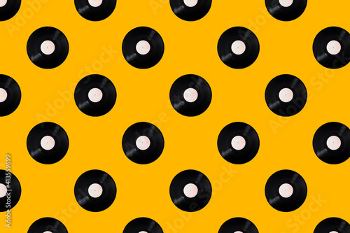 Pattern of vinyl records on a yellow background. Minimal trendy composition