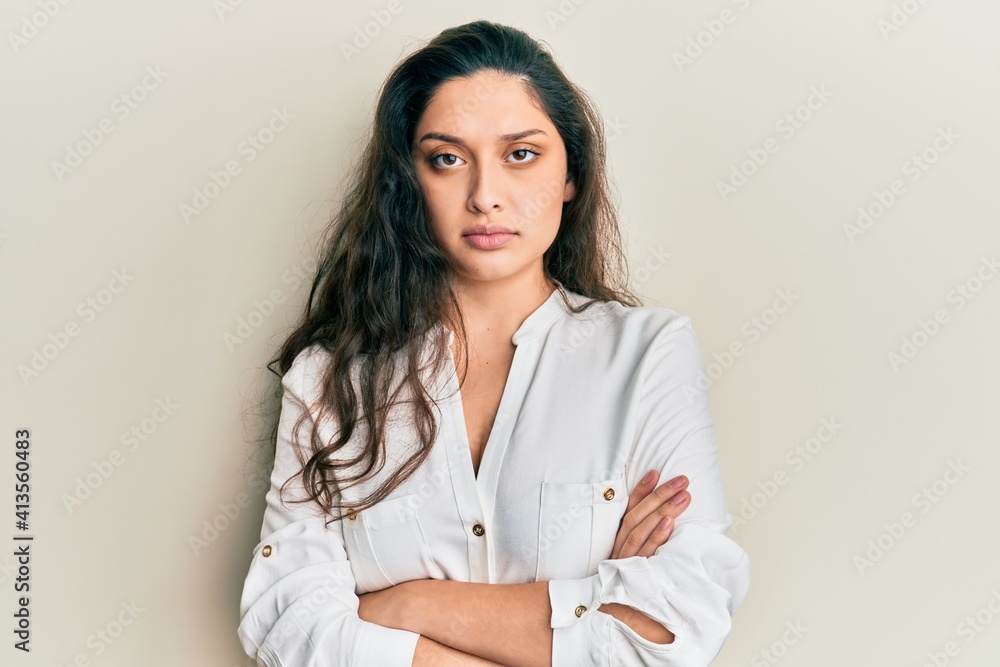 Beautiful middle eastern woman wearing casual clothes skeptic and nervous, disapproving expression on face with crossed arms. negative person. Beautiful middle eastern woman wearing casual clothes skeptic and nervous, disapproving expression on face with crossed arms. negative person.