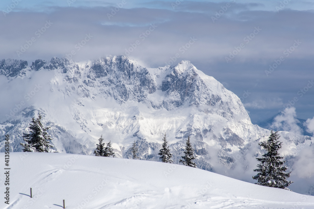 The Austrian Alps in winter near Kitzbuhel. Behind the snow covered fir trees the fog rises revealing the magnificent mountain peaks.
The Austrian Alps in winter near Kitzbuhel. Behind the snow covered fir trees the fog rises revealing the magnificent mountain peaks.