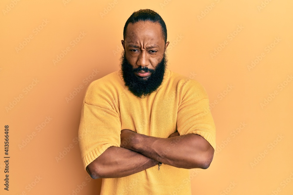Young african american man wearing casual clothes skeptic and nervous, disapproving expression on face with crossed arms. negative person. Young african american man wearing casual clothes skeptic and nervous, disapproving expression on face with crossed arms. negative person.