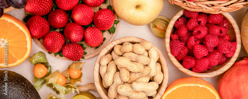 Group Fruits mixed with banana, orange, strawberry and nuts, concept health food and diet, vegetarian food in the top view on the wood table.