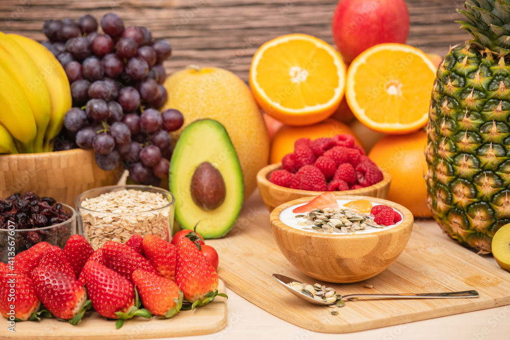 Group Fruits mixed with banana, orange, strawberry and nuts, concept health food and diet, vegetarian food in the top view on the wood table. Group Fruits mixed with banana, orange, strawberry and nuts, concept health food and diet, vegetarian food in the top view on the wood table.