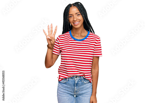 Schilderij op canvas Beautiful hispanic woman wearing casual clothes showing and pointing up with fingers number four while smiling confident and happy