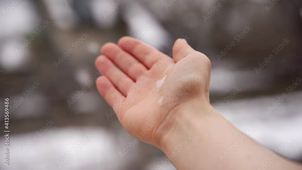 Catching white snowflakes in a winter storm with the right hand out of the window. Chasing snow while it is falling down during winter season. Catching white snowflakes in a winter storm with the right hand out of the window. Chasing snow while it is falling down during winter season.
