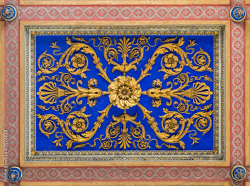 Golden flowery decoration on the ceiling of the Basilica of San Nicola in Carcere in Rome, Italy.