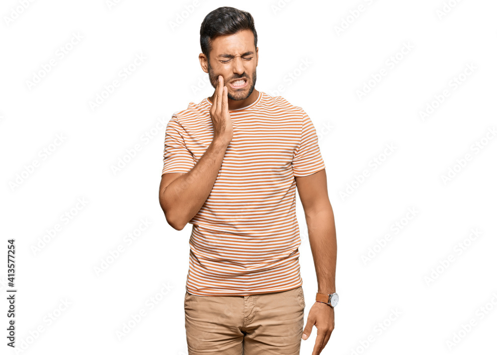 Handsome hispanic man wearing casual clothes touching mouth with hand with painful expression because of toothache or dental illness on teeth. dentist Handsome hispanic man wearing casual clothes touching mouth with hand with painful expression because of toothache or dental illness on teeth. dentist