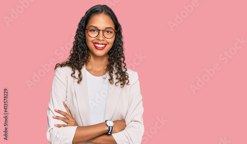 Young african american girl wearing business clothes happy face smiling with crossed arms looking at the camera. positive person. photo