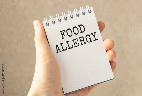Doctor holding a card with text Food Allergy medical concept