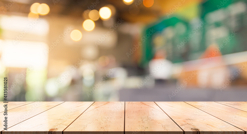 Empty wooden table top with lights bokeh on blur restaurant background