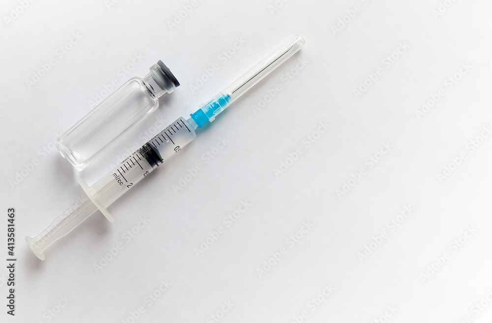 One medical glass bottle with syringe. a medical disposable syringe with a needle. Medical concept shows a medical test tube and vaccines against coronavirus. Copy place. High quality photo One medical glass bottle with syringe. a medical disposable syringe with a needle. Medical concept shows a medical test tube and vaccines against coronavirus. Copy place. High quality photo