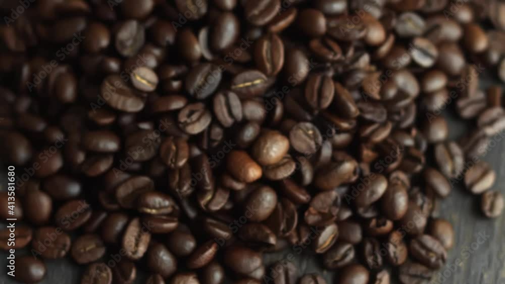 Roasted arabica coffee beans scattered on a wooden table. Fresh coffee beans. Espresso, americano, doppio, cappuccino, latte. Robusta. Selective focus. Roasted arabica coffee beans scattered on a wooden table. Fresh coffee beans. Espresso, americano, doppio, cappuccino, latte. Robusta. Selective focus.