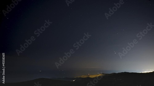 Stars, Planets Jupiter and Saturn Time Lapse Over the Sea. 