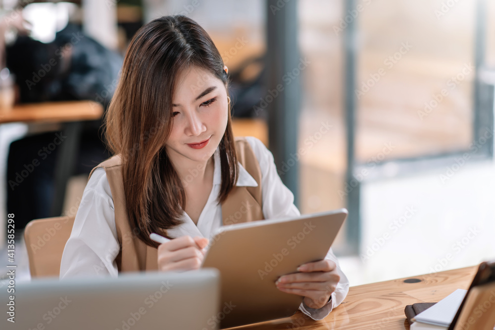 Beautiful woman Asian using digital tablet work at the office. Beautiful woman Asian using digital tablet work at the office.
