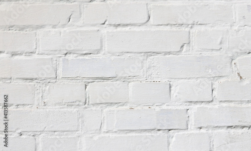 Beautiful brick background with old bricks in white paint, whole bricks and cracked bricks