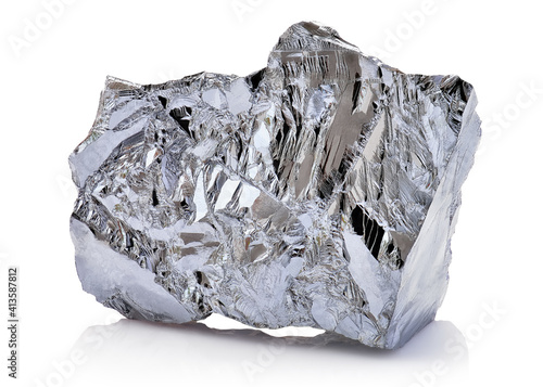Macro shoot of piece of nickel metal ore isolated on a white background. Closeup photo of amazing shiny mineral rough photo