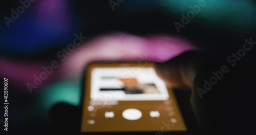 Smartphone music streaming application - blurry defocused concept footage
