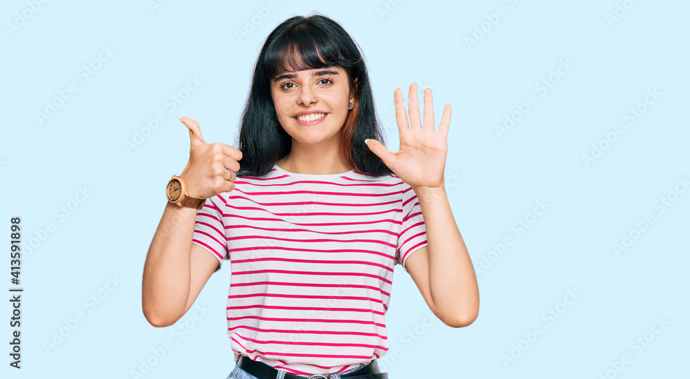 Young hispanic girl wearing casual clothes showing and pointing up with fingers number six while smiling confident and happy. Young hispanic girl wearing casual clothes showing and pointing up with fingers number six while smiling confident and happy.