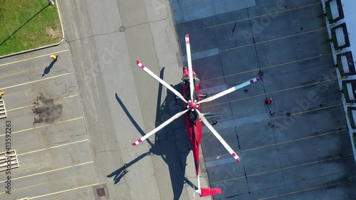 Birds Eye View of a Heavy Lift Helicopter Next To a Large Commercial Warehouse