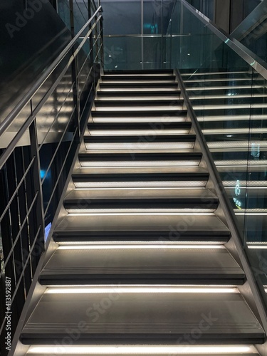 a modern stairway with lights going upstairs