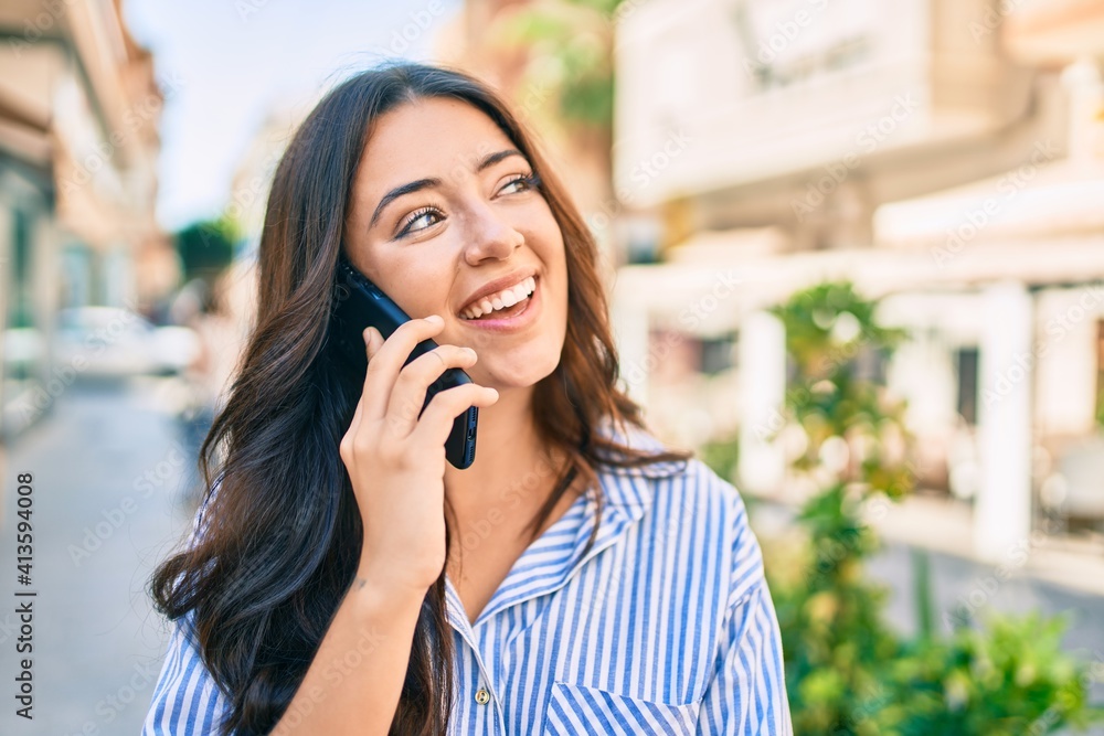 Young hispanic businesswoman smiling happy talking on the smartphone at the city. Young hispanic businesswoman smiling happy talking on the smartphone at the city.
