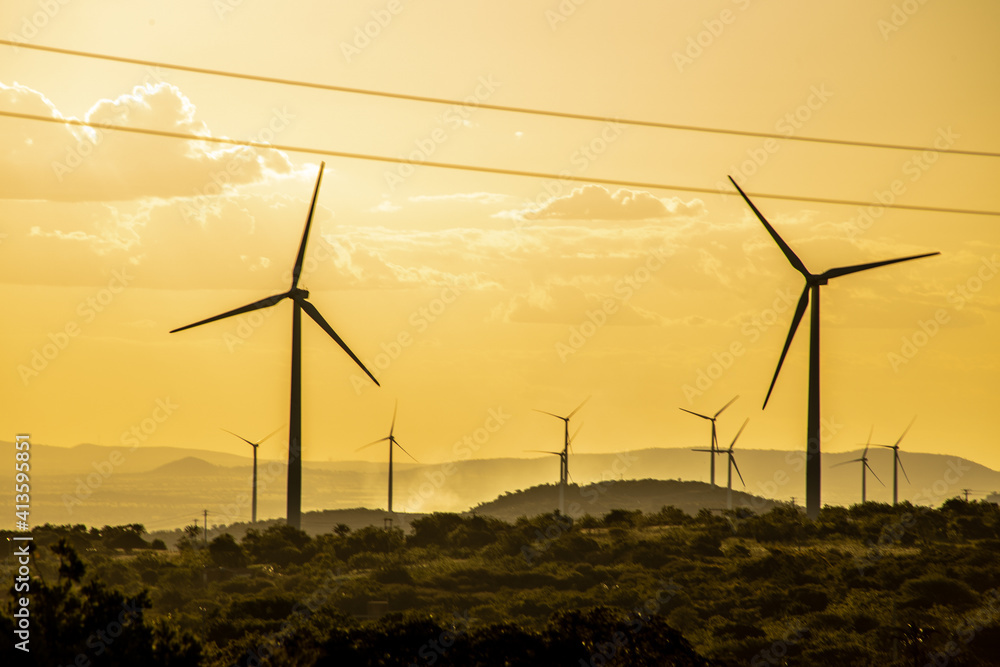 Obraz premium wind turbine at sunset