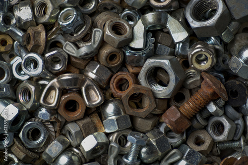 Macro view of a collection of old nuts and bolts of various types and sizes.