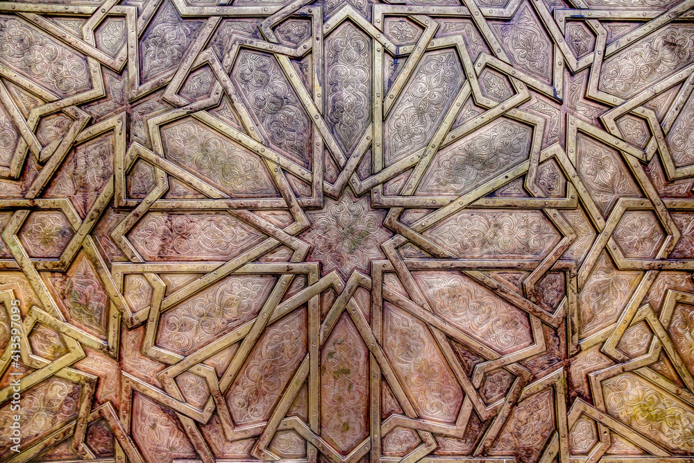 Intricate tile patterns, metal work and plaster carvings adorning  building exteriors in Fez Morocco