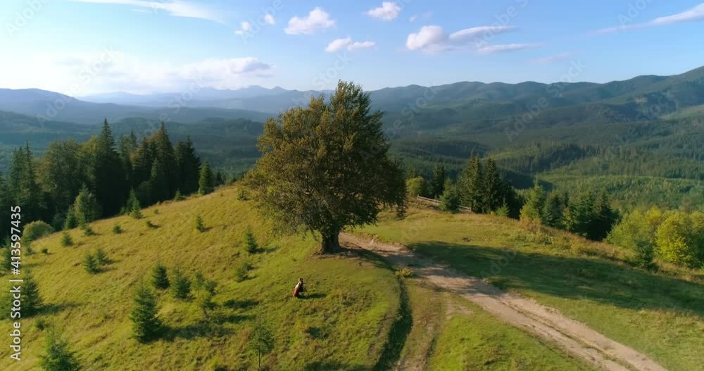 Beautiful nature. Green trees on a hill with a trail. Mountains landscape. People rest in fresh air. Amazing nature in summer. Aerial view. Beautiful nature. Green trees on a hill with a trail. Mountains landscape. People rest in fresh air. Amazing nature in summer. Aerial view.