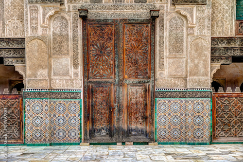 Intricate tile patterns, metal work and plaster carvings adorning building exteriors in Fez Morocco