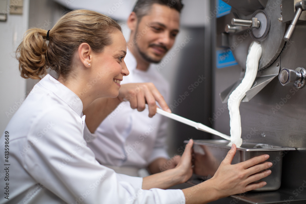 chef and woman assistant filling ice cream chef and woman assistant filling ice cream