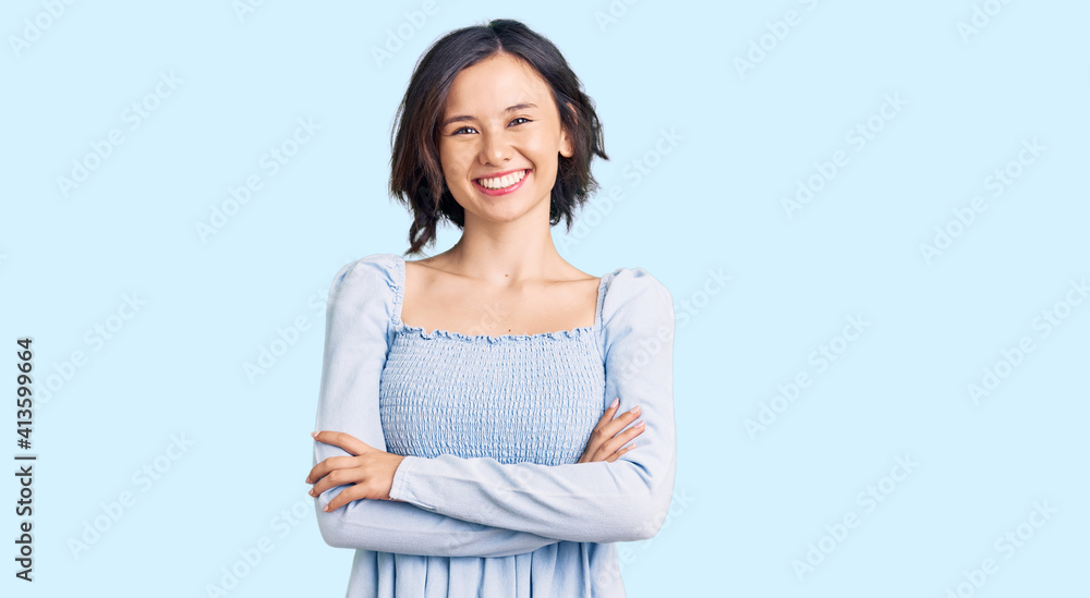 Young beautiful girl wearing casual clothes happy face smiling with crossed arms looking at the camera. positive person. Young beautiful girl wearing casual clothes happy face smiling with crossed arms looking at the camera. positive person.